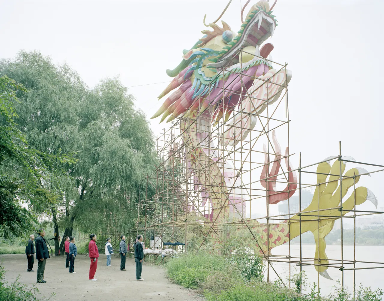 People doing morning exercise in front of a dragon lam, Gansu, 2011 © Zhang Kechun