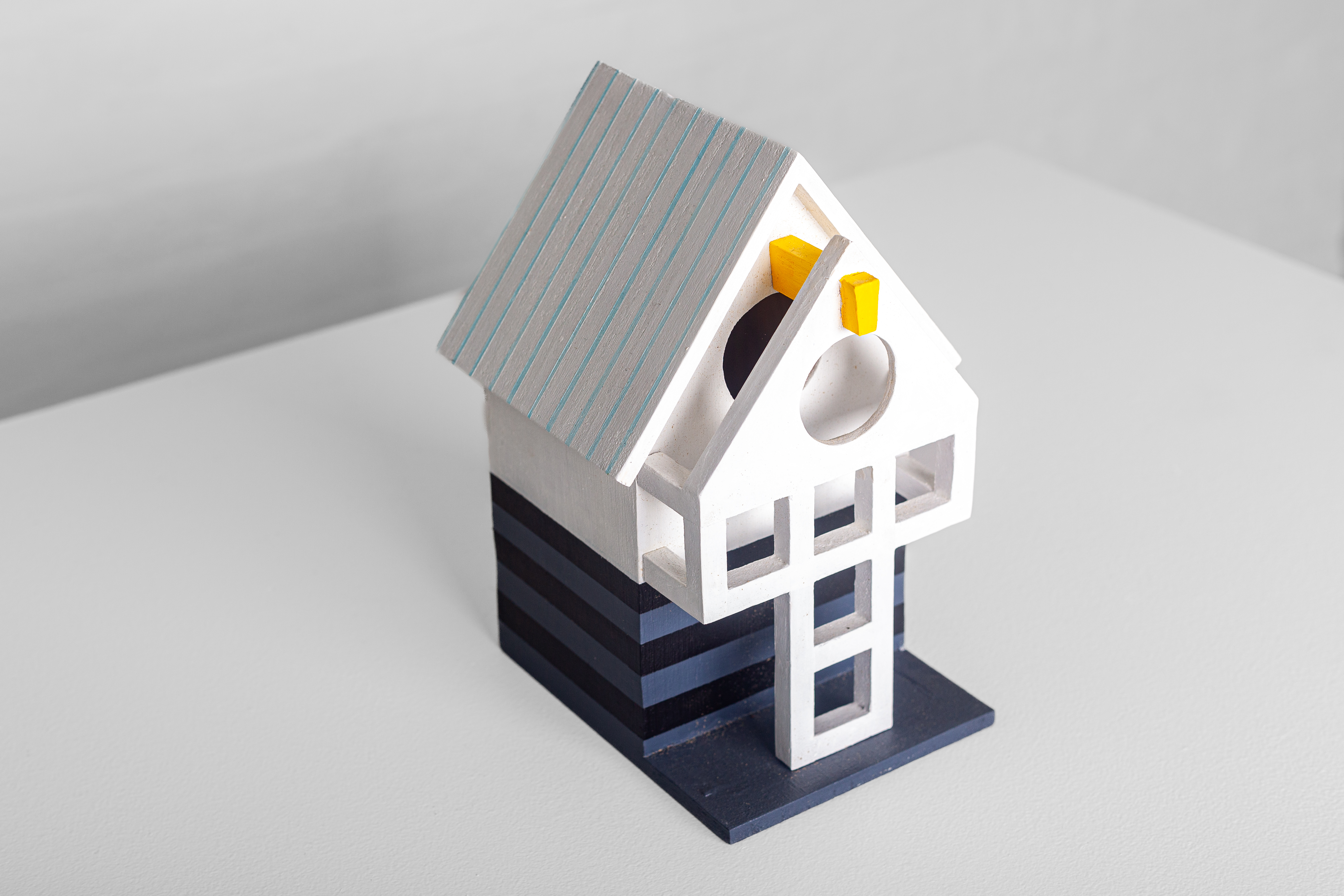 The Vermonter Birdhouse by Jason Sargenti. ""As the cultural epicenter of my region (NYC) hemorrhage its moneyed populace, they venture north to gobble up real estate and bend towns to their will," says Jason. "As out of place and oblivious as Tim Burton's cast of exurbs from Beetlejuice."
