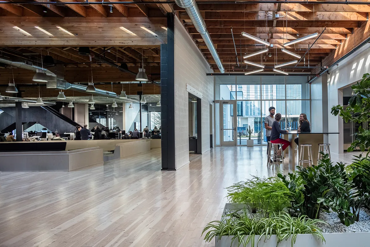 Swift Kitchen/Creative Quad: The north entrance opens onto the kitchen and creative team workspace. A crisscross staircase leads to meeting rooms on the mezzanine.