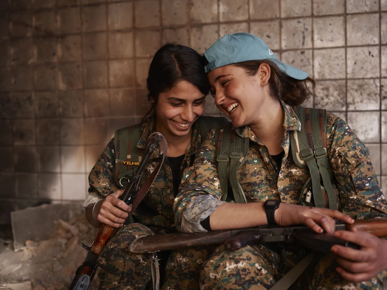 Silava and Berivan share a laugh in an abandoned ISIS base. Shengal, Nineveh Governorate, Iraq, November 23, 2015. From [We Came From Fire​](​https://amzn.to/2L9l8Vm) by Joey L. – published by powerHouse Books