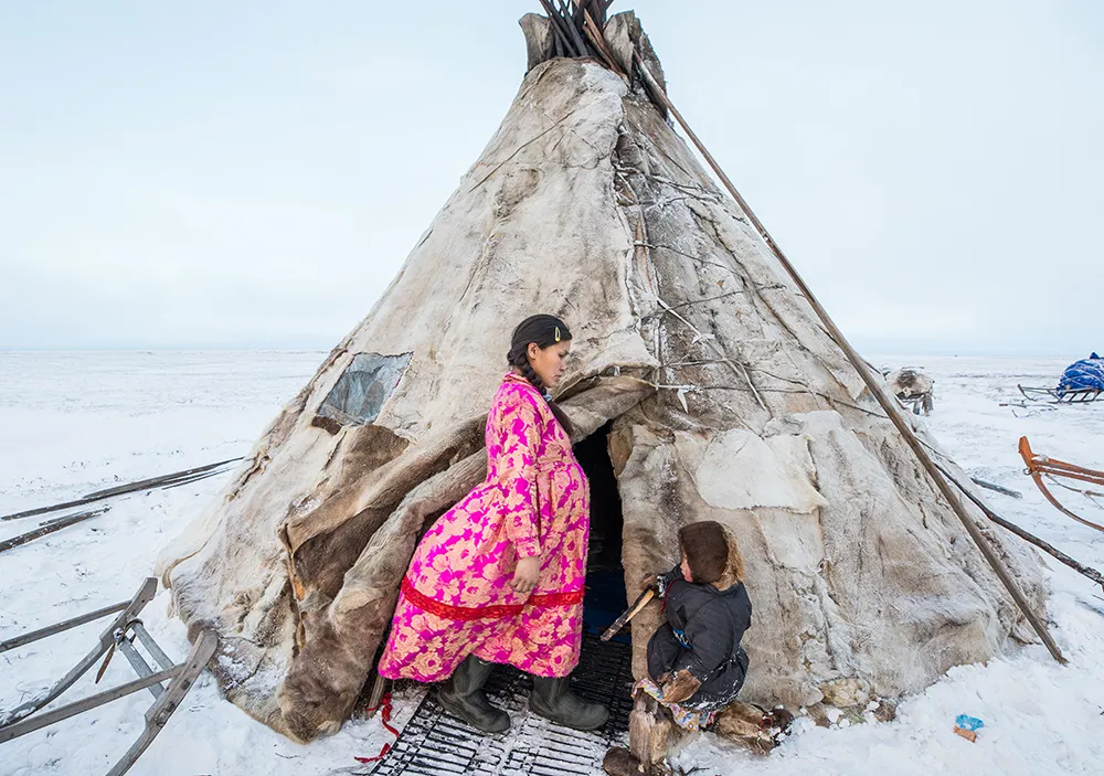 Lena and her daughter Christina are standing at the entrance of their chum. Lena’s large belly is obvious under her dress, and there is no doubt that she is nine months pregnant. Image credit: Alegra Ally/Schilt Publishing